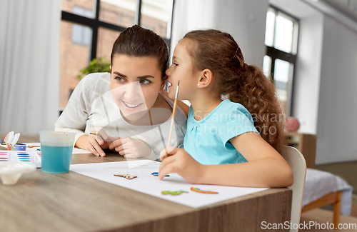 Image of happy mother with little daughter drawing at home