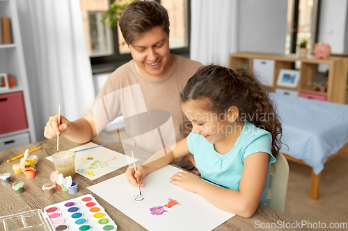 Image of happy father with little daughter drawing at home