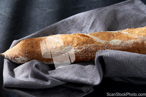 Image of close up of baguette bread on kitchen towel