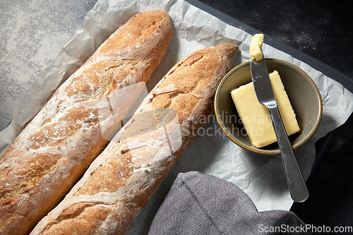 Image of close up of bread, butter and knife on towel