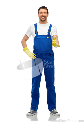 Image of happy male worker or cleaner in overall and gloves