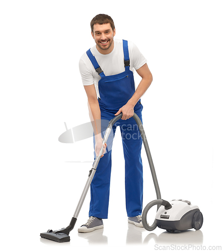 Image of male worker cleaning floor with vacuum cleaner