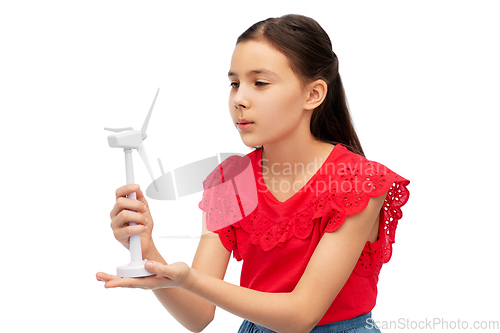 Image of smiling girl with toy wind turbine