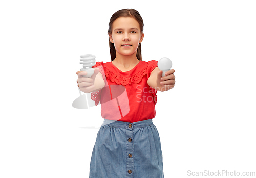 Image of smiling girl comparing different light bulbs