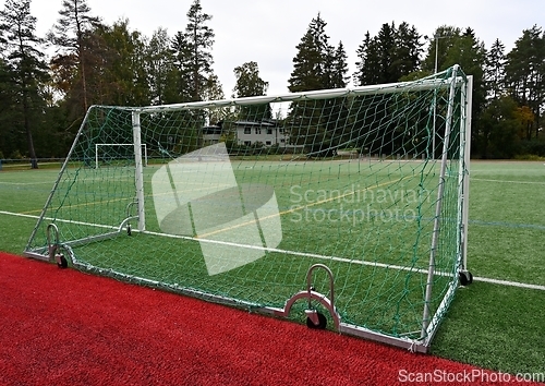 Image of soccerl goal on wheels in a stadium 