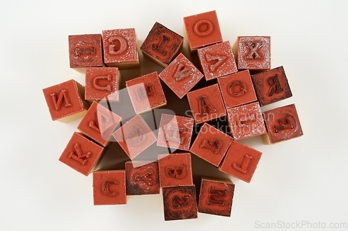 Image of rubber stamps of letters of the Latin alphabet in disarray 