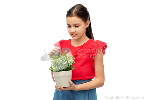 Image of happy smiling girl holding flower in pot