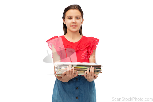 Image of smiling girl with magazines sorting paper waste