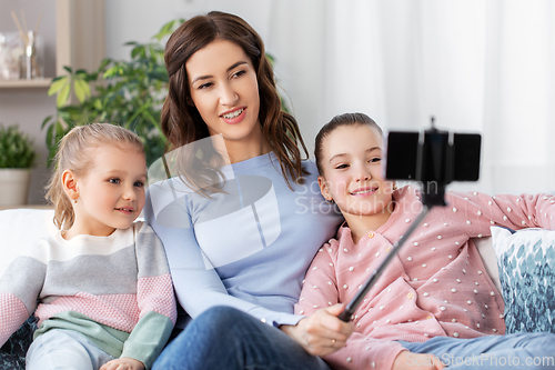 Image of happy family taking selfie by smartphone at home