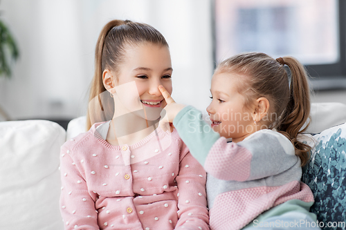 Image of two happy smiling little girls or sisters at home