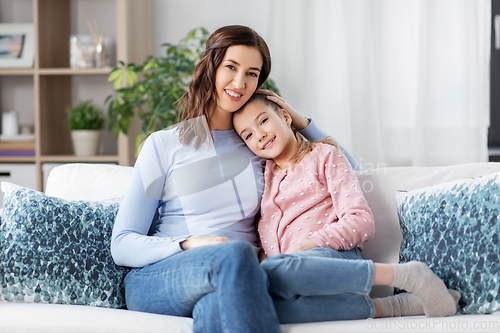 Image of happy smiling mother with daughter at home