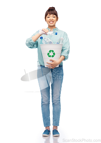 Image of smiling young woman sorting plastic waste