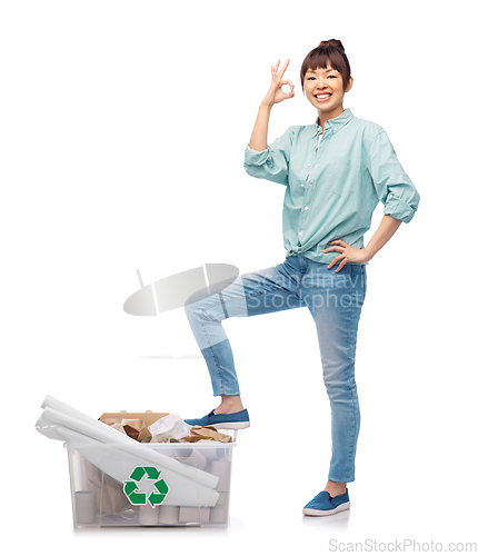 Image of happy smiling asian woman sorting paper waste