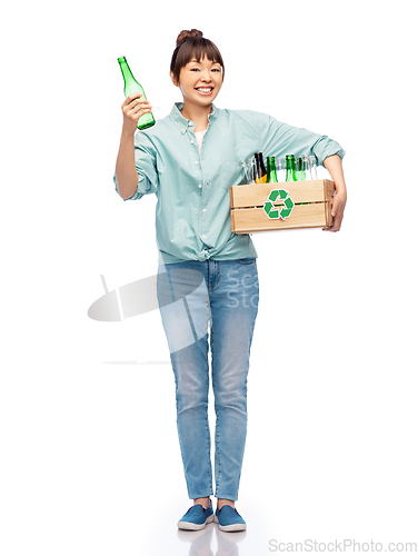 Image of smiling young asian woman sorting glass waste