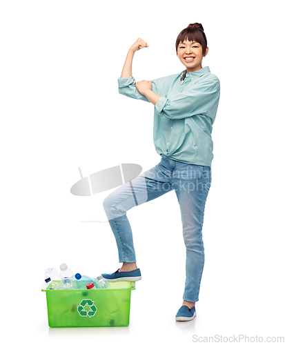 Image of smiling young asian woman sorting plastic waste