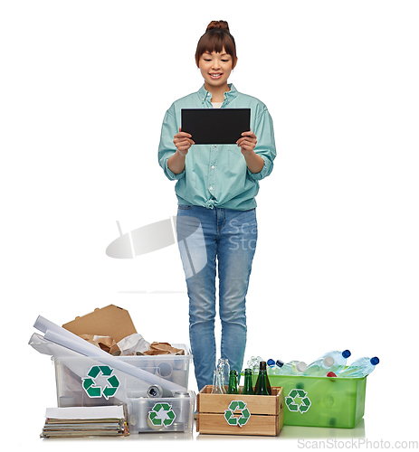 Image of smiling asian woman with tablet pc sorting waste