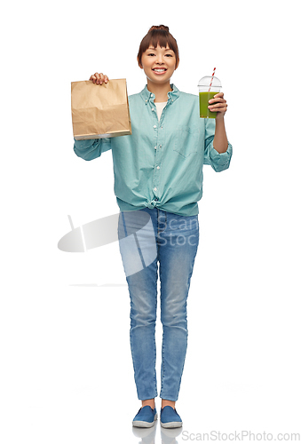 Image of happy asian woman with drink and food in paper bag