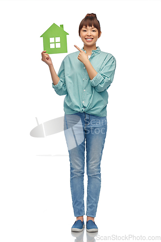 Image of smiling asian woman holding green house