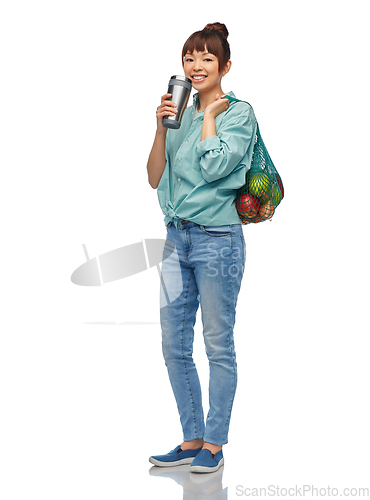 Image of happy smiling woman with food in reusable net bag