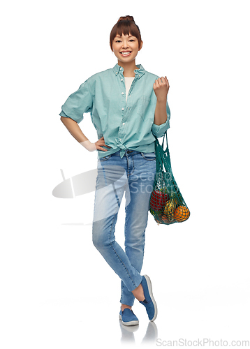 Image of happy asian woman with food in reusable string bag