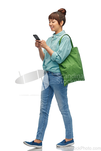 Image of woman with phone and reusable food shopping bag