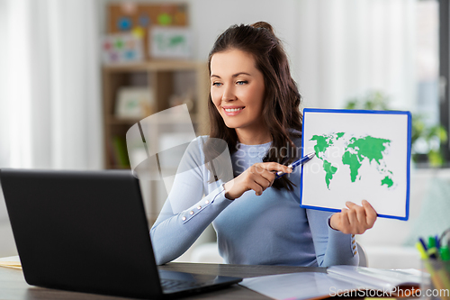 Image of teacher with world map having online class at home