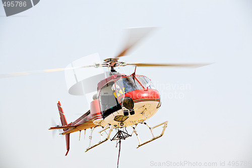 Image of helicopter picking up cargo