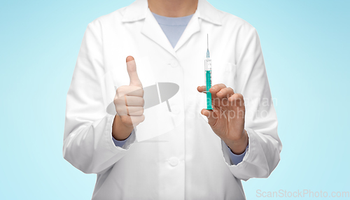 Image of close up of doctor with syringe showing thumbs up