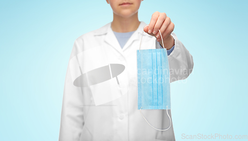 Image of female doctor showing medical mask