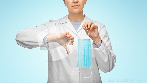 Image of female doctor with mask showing thumbs down