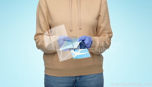 Image of woman with mask, passport and air ticket