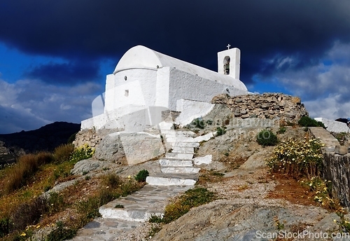 Image of Dramatic view of Christian Orthodox church of Agios Konstantinos in the town of Chora in Serifos island, Greece under cloudy sky