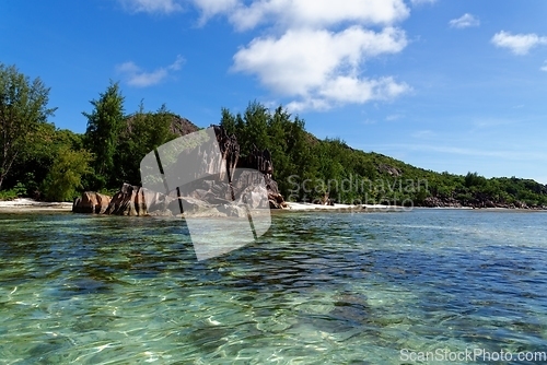 Image of Beach on Curieuse Island, Seychelles, with lava stone rocks and lush vegetation