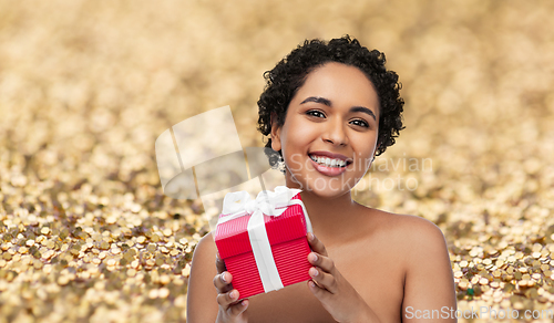 Image of portrait of young african american woman with gift