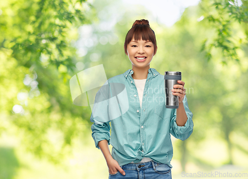 Image of woman with thermo cup or tumbler for hot drinks