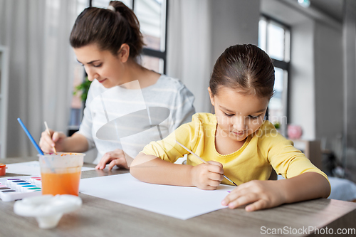 Image of mother with little daughter drawing at home