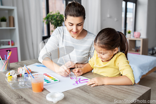 Image of mother with little daughter drawing at home