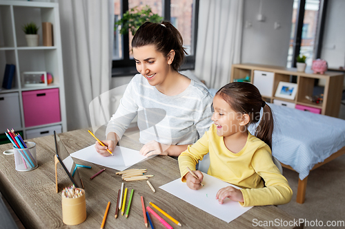 Image of mother with little daughter drawing at home