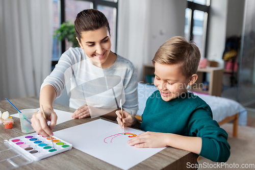 Image of mother and son with colors drawing at home