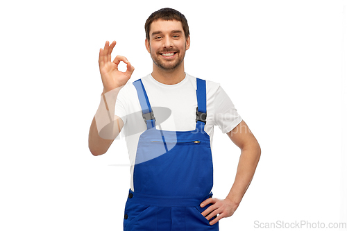 Image of happy smiling male worker or builder showing ok