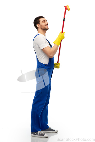 Image of male cleaner in overal with window cleaning mop