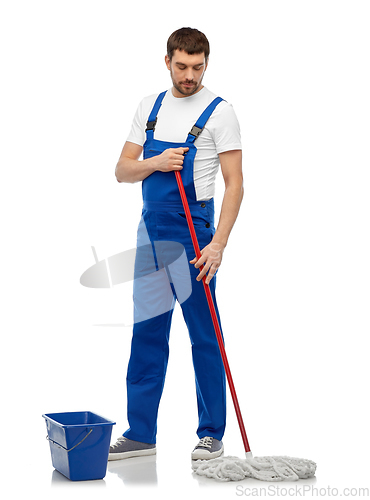 Image of male cleaner cleaning floor with mop and bucket