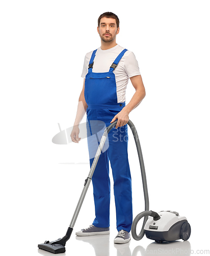 Image of male worker cleaning floor with vacuum cleaner