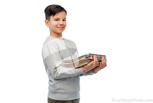 Image of smiling boy with magazines sorting paper waste