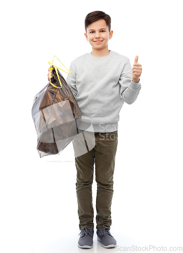 Image of smiling boy with paper garbage in plastic bag