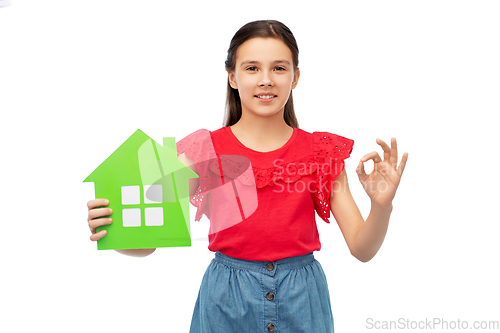 Image of happy little girl with green house icon showing ok