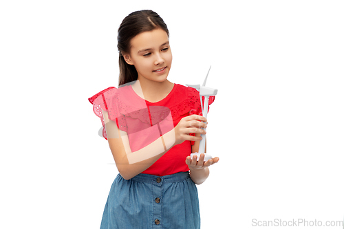 Image of smiling girl with toy wind turbine