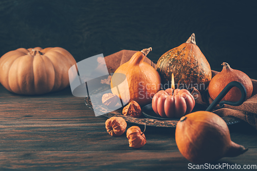 Image of Happy Thanksgiving Day background, wooden table decorated with Pumpkins and Candles