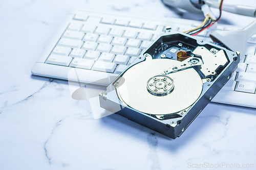 Image of Open Hard drive on keyboard in blue tone