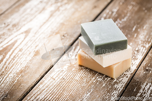 Image of Natural soap bars on wooden background